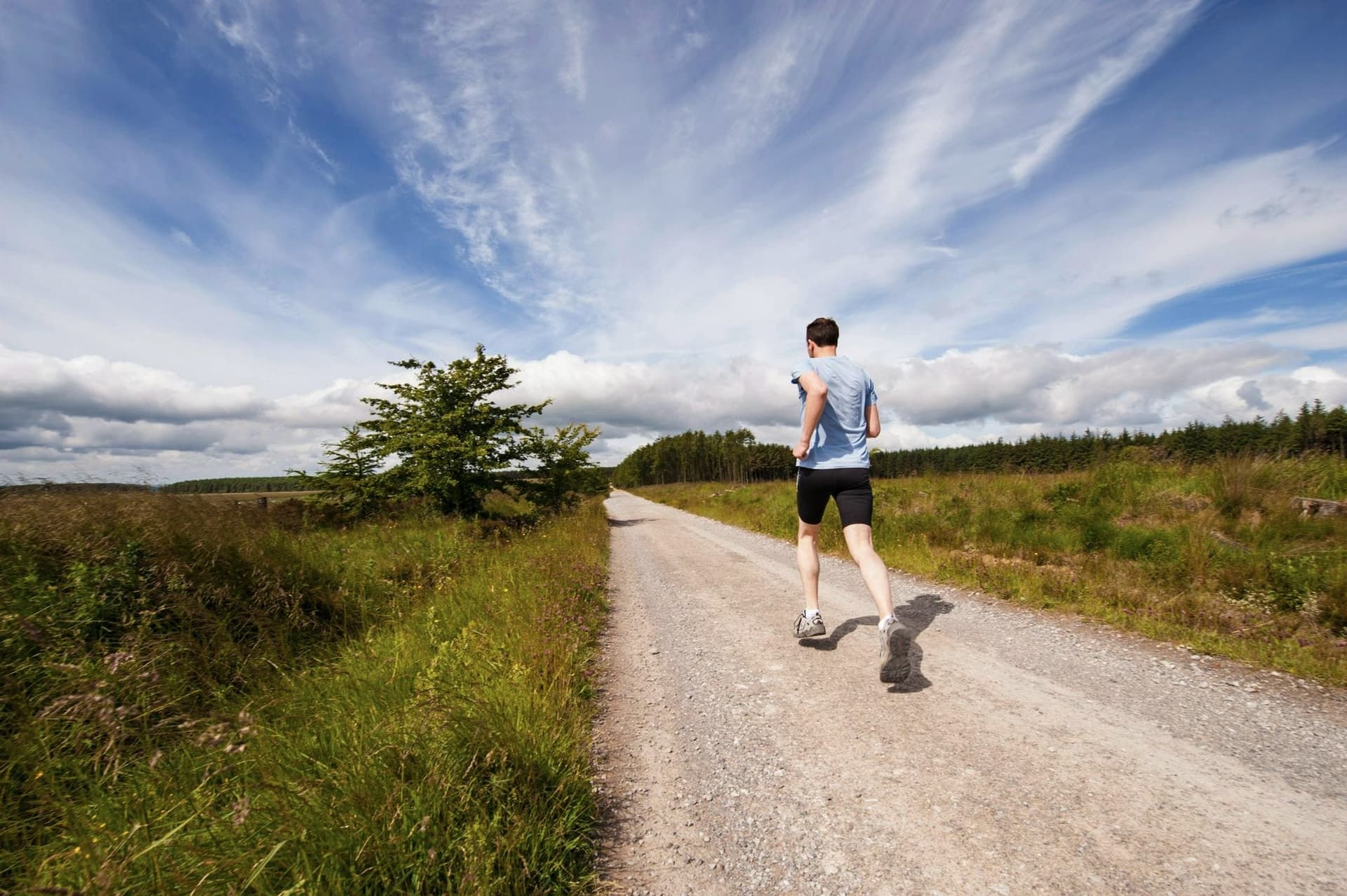 Runner heading down an open country road