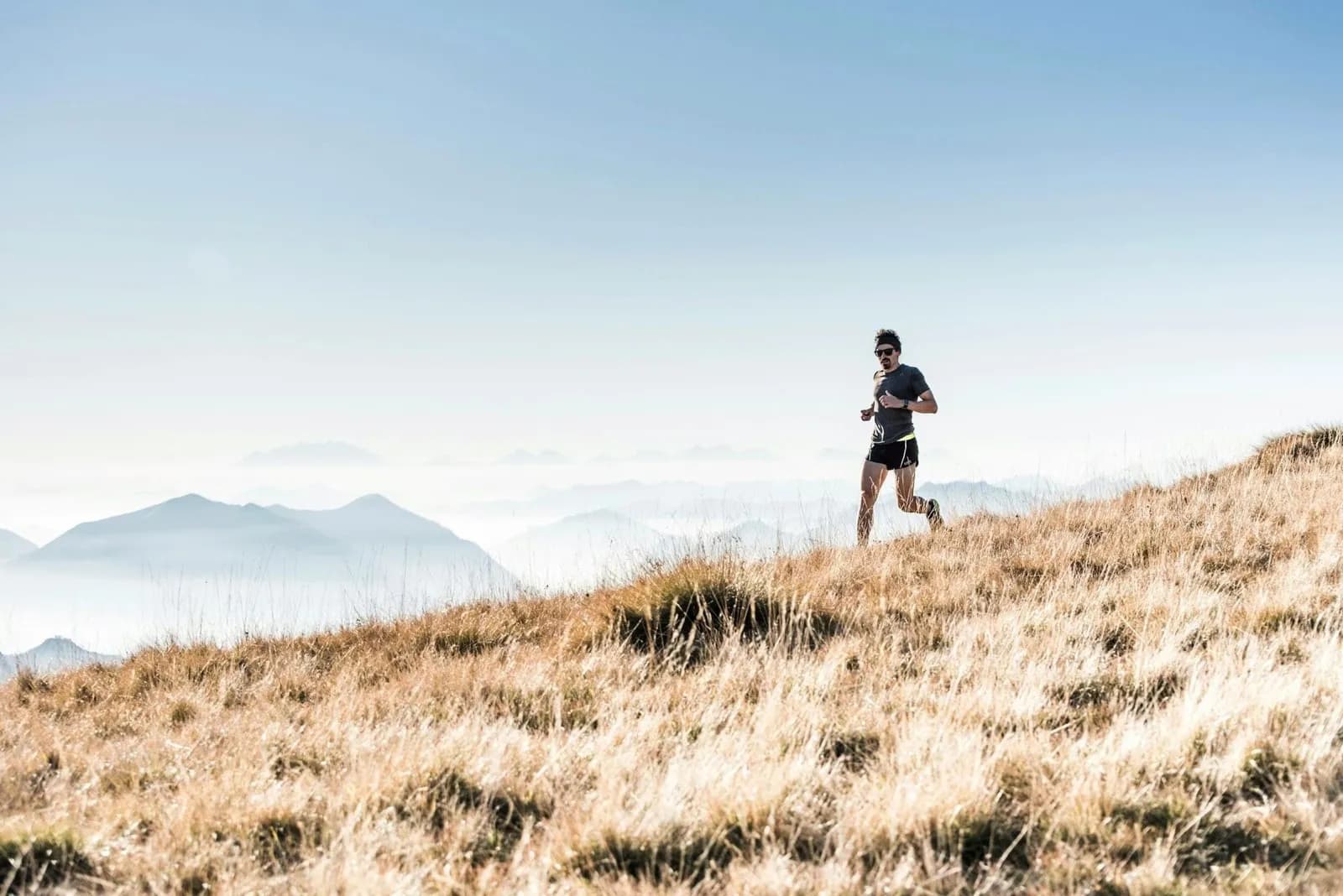 Runner on a golden hillside trail
